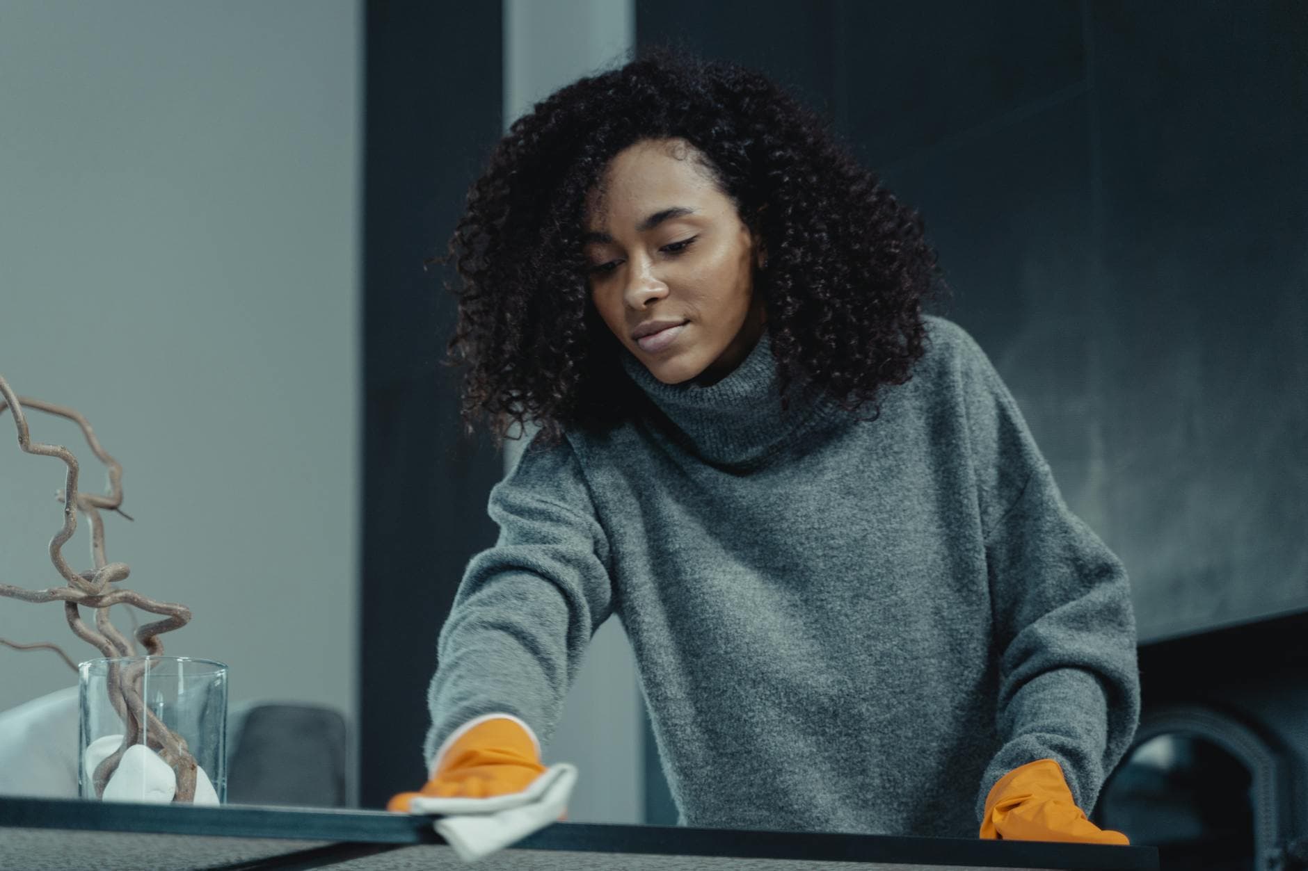 The NYC Maid cleaner wiping a table in a New York City apartment — cleaning services in Fieldston, Bronx
