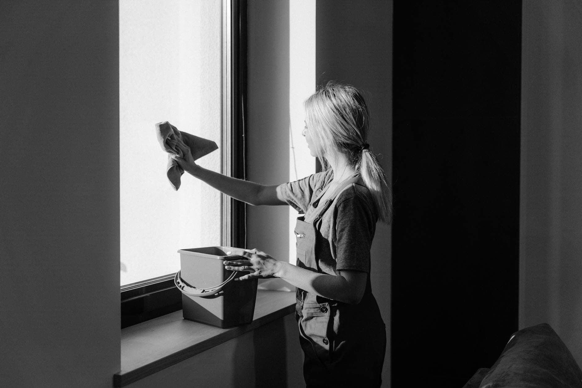 Professional window cleaning in a New York City apartment using cloth and bucket — cleaning services in Arrochar, Staten Island